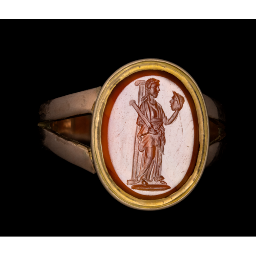A 19th c. gold ring set with a Roman carnelian intaglio. Melpomene, muse of tragedy.